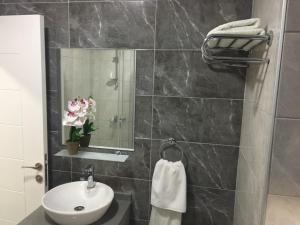a bathroom with a sink and a toilet and a mirror at Alya Rooms in Lefkosa Turk +11 photos