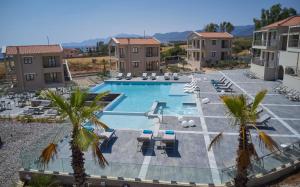 an overhead view of a swimming pool with chairs and palm trees at Sempre Viva Suites in Monemvasia