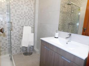 a bathroom with a sink and a shower at Luz Beach Center in Luz +18 photos