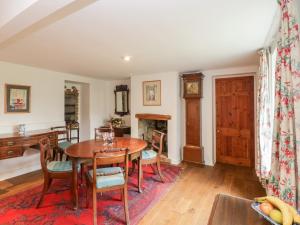 a dining room with a table and chairs at Church View in Tisbury