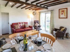 a living room with a table and chairs at Mill Cottage in Mansfield