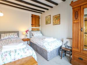 מיטה או מיטות בחדר ב-Mill Cottage