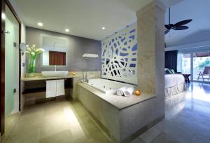 
a large white bathroom with a marble counter top at TRS Turquesa Hotel - Adults Only - All Inclusive in Punta Cana
