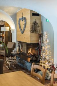 a living room with a fireplace and a christmas tree at Le Relais du Galibier in Valloire
