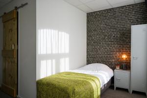 A bed or beds in a room at Hotel Old Dutch Bergen op Zoom