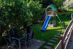 a playground with a slide and a table and chairs at Ferienhaus Mariele in Lohberg