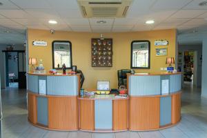 a waiting room with two counters in a hospital at Hotel The Originals Tours Sud Pic Epeiche (ex Inter-Hotel) in Montbazon