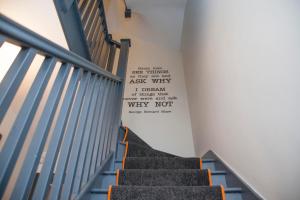 a stairway with a sign on the wall at higgihaus #3a 4 Bed Sleeps up to 12 Big Groups Hip Location in Bristol
