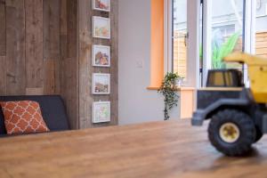 a toy truck sitting at a table in a room at higgihaus #3a 4 Bed Sleeps up to 12 Big Groups Hip Location in Bristol