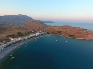 an aerial view of a beach with boats in the water at Haraki Village in Haraki