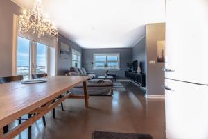 a kitchen and dining room with a table and a refrigerator at GreenKey House B16 in Keflavík