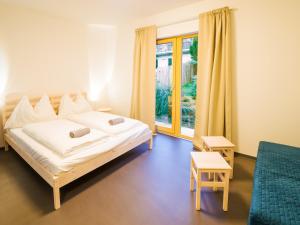 Postel nebo postele na pokoji v ubytování Hostel Zahrada Mikulov