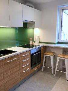 a kitchen with wooden cabinets and a stove top oven at Apartament Karpaty in Krynica Zdrój