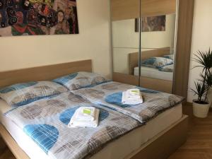 a bedroom with a bed with towels on it at Apartment Náměstí Bratří Synků in Prague