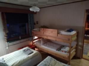 a room with two bunk beds and a bed at Kiiloselän Poropirtti in Kakslauttanen