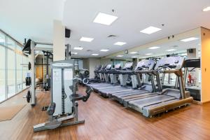 a gym with rows of treadmills and ellipticals at Radisson Vila Olimpia Sao Paulo in Sao Paulo