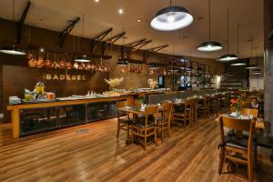 
a large kitchen with wooden floors and wooden tables at Radisson Vila Olimpia Sao Paulo in São Paulo
