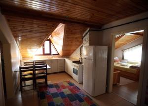 een kleine keuken met een witte koelkast en een tafel bij Mekan Ilica Apart Otel in Karacasu