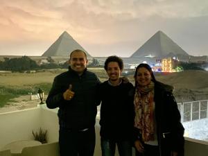 a group of people standing in front of the pyramids at Farida Pyramids Boutique Hotel in Cairo