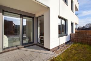 a house with large windows on the side of it at Elite Apartments Marine Suite in Gdańsk