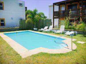 a swimming pool in the backyard of a house at Apartamentos La Playa in Piriápolis
