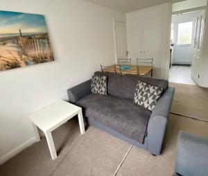 a living room with a couch and a table at Surf's Up in Perranporth, Cornwall Coastal Holidays in Perranporth