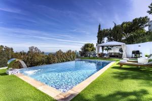 a swimming pool in the yard of a house at Luxury villa with sea views - heated pool-Jacuzzi in Benalmádena