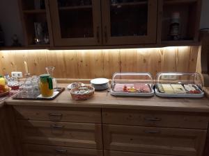 a kitchen counter with two trays of food on it at Viehhofbauer in Maria Alm am Steinernen Meer