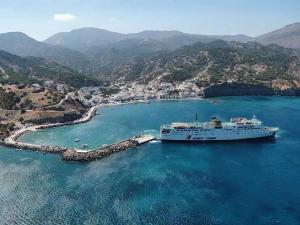 un bateau de croisière est amarré dans un port dans l'établissement Dorana Apartments & Trekking Hotel, à Diafani