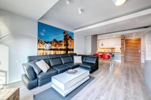 a living room with a couch and a table at 3 City Apartments - Waterlane Valhalla in Gdańsk