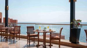 uma mesa e cadeiras numa varanda com vista para o oceano em Club Regina Los Cabos em San José del Cabo