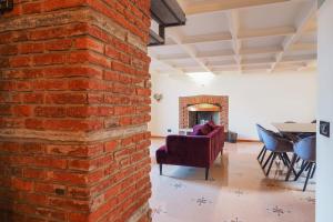 an exposed brick wall in a living room with a couch at Unique Duomo Luxury Property in Milan