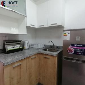 a small kitchen with a sink and a refrigerator at Host - San Isidro Sta Catalina in Lima