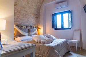 A bed or beds in a room at Relais La Masseriola