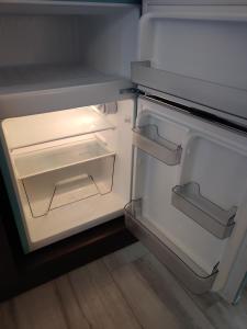 an empty refrigerator with its door open in a kitchen at Kings Inn in San Diego