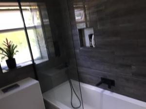 a bathroom with a bath tub and a window at Kings Lynn, Double bedroom, newly renovated bathroom in King's Lynn