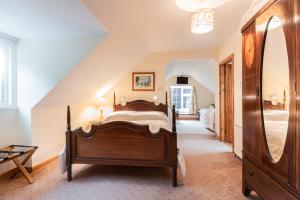 a bedroom with a large bed and a staircase at An Bruachan B&B in Kenmare