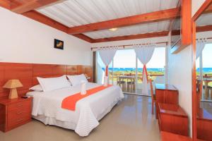 a bedroom with a bed and a view of the ocean at Hotel La Casa de Judy in Puerto Ayora