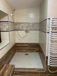 a shower with a glass door in a bathroom at Privat FoRest in Liptovský Mikuláš +81 photos