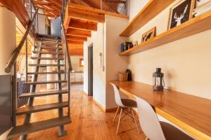 a staircase in a room with a desk and chairs at Bog Antilhue - Casa 2 cuartos in Villa La Angostura