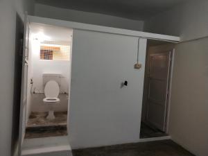 an open door to a bathroom with a toilet at Mayurapriya Inn in Chennai +7 photos
