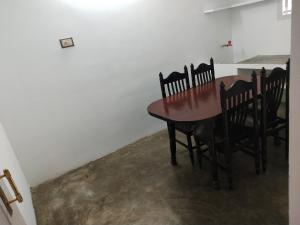 a dining room table and chairs in a room at Mayurapriya Inn in Chennai