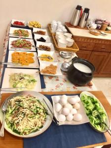 a table with many plates of food on it at He Sen B&B in Kenting