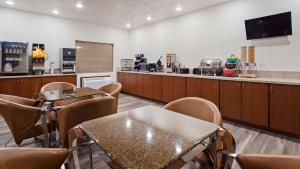 a waiting room with tables and chairs and a counter at SureStay Plus Hotel by Best Western Vernal in Vernal