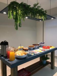a table with many plates of food and drinks at Fish Inn Hotel in Barra Velha +20 photos