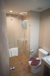 a bathroom with a shower and a toilet and a sink at Proud Khaoyai in Pak Chong