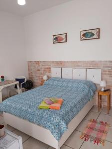a bedroom with a bed with two pillows on it at Maranata Suítes - 2 minutos de carro até o mar in Peruíbe
