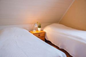 a bedroom with two beds and a lamp on a night stand at Strandhaus Nr. 9 OG li. in Dahme
