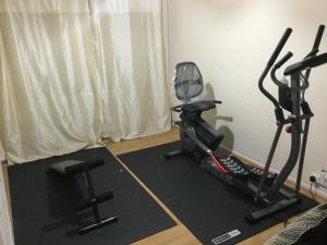 a room with a treadmill and a exercise bike at Holiday / vacation Double Room in Greater manchester in Summerseat