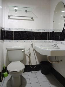 a bathroom with a toilet and a sink at GloRy BeAch ResOrt private apartment in Port Dickson